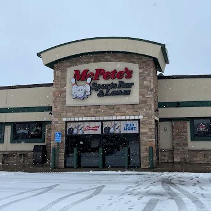 Front view of Ma Petes Sports Bar & Lanes with snow, perfect for food and drink lovers.
